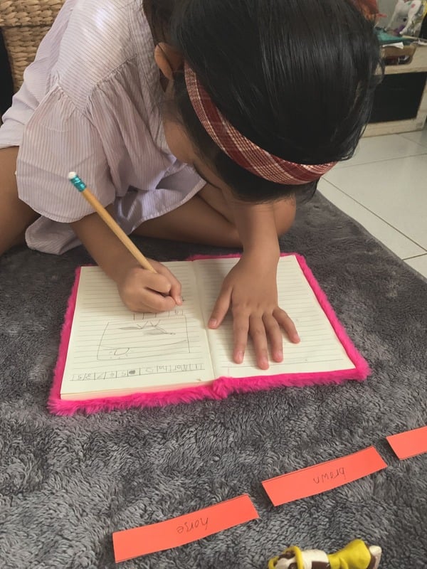 MLI kid writing MLI kid writing